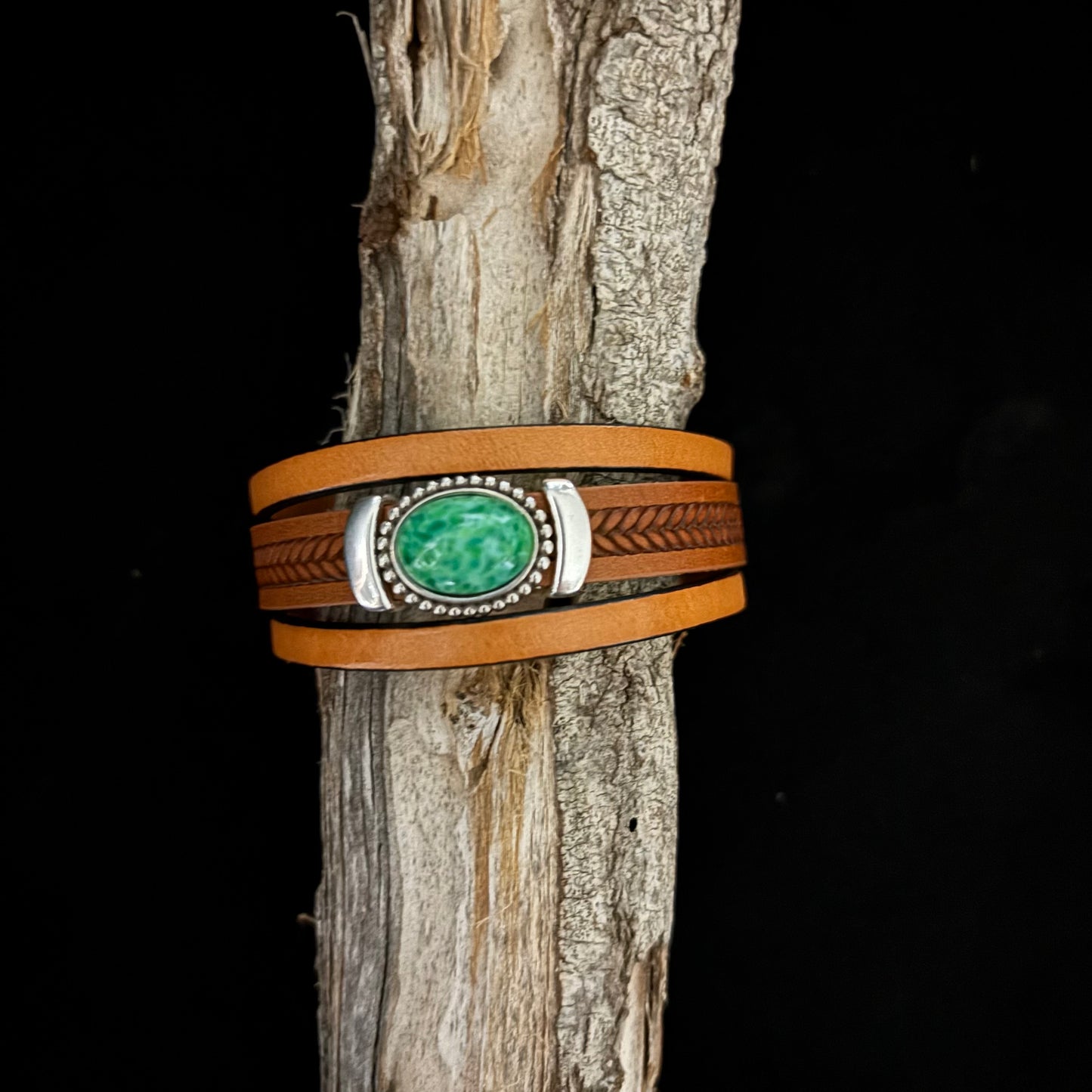stacked bracelet with green slider on brown leather