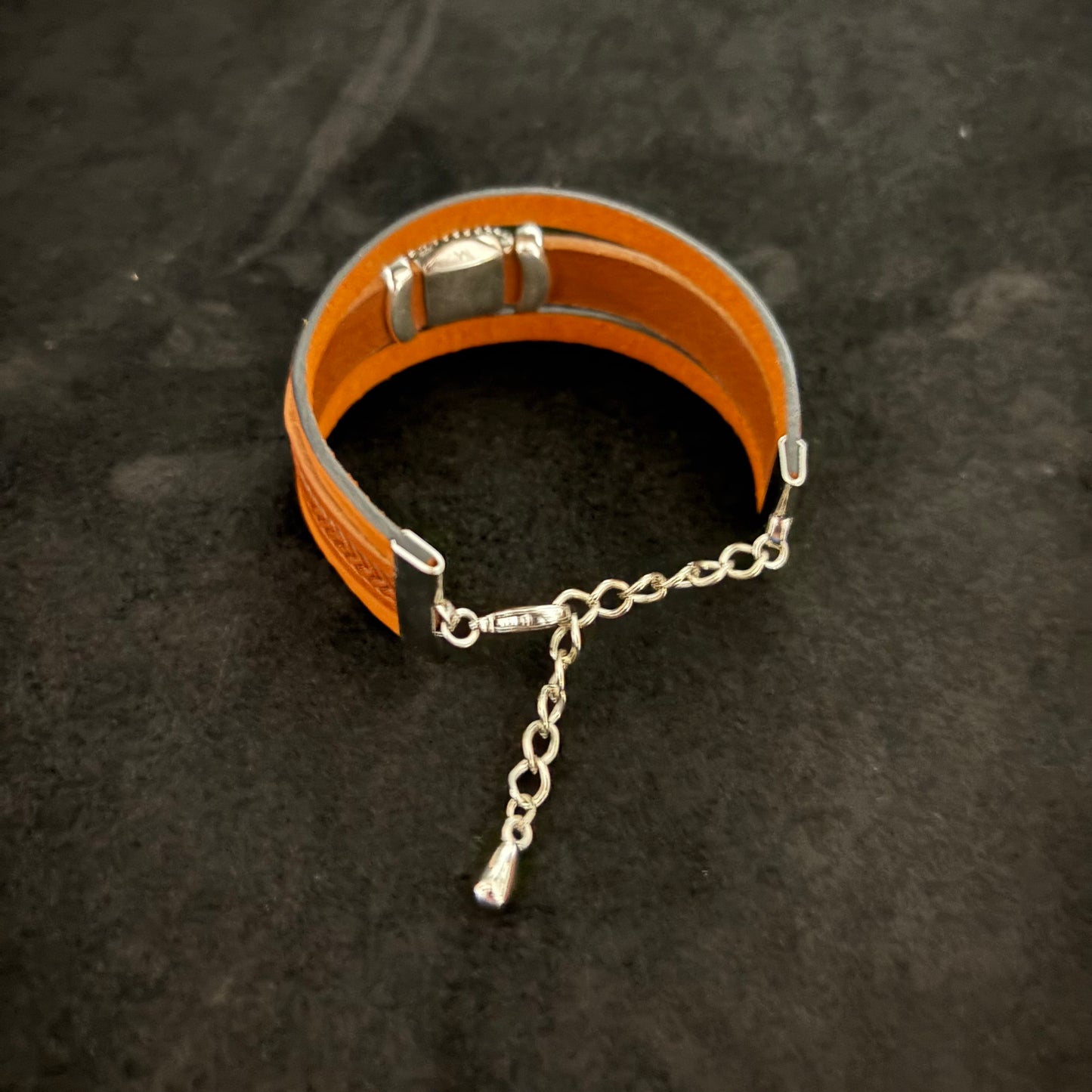 stacked bracelet with green slider on brown leather